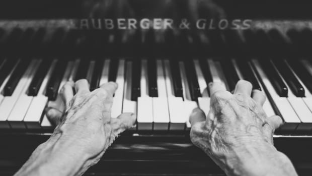 Elderly old people hands piano keyboard
