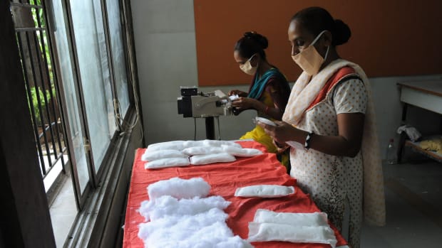 Members of the Self Employed Women's Association (SEWA) make low-cost sanitary pads at their facility in Ahmedabad, India, on September 3rd, 2012. Prompted by the widespread suffering of women and girls in rural areas who continue to be plagued by unhygienic old cloth pieces or rags during their menstrual cycle periods, SEWA is manufacturing low-cost sanitary pads with a production capacity at 2,000 pads per day.
