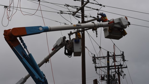Linesmen from Pacific Gas and Electric repair power lines after the Valley Fire swept through the town of Middletown, California, on September 16th, 2015.