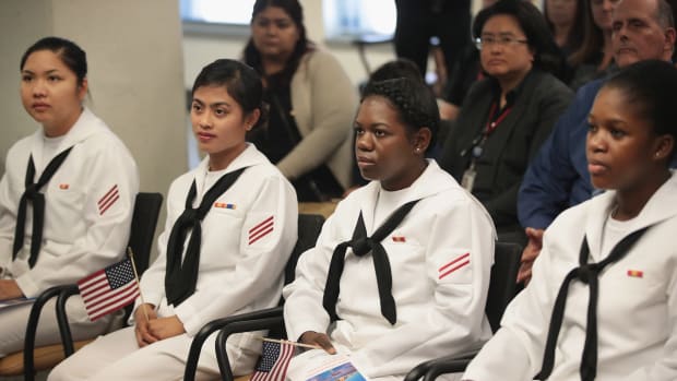 Sailors, serving in the U.S. Navy at Naval Station Great Lakes, are sworn in as U.S. Citizens during a ceremony on September 15th, 2017, in Chicago, Illinois.