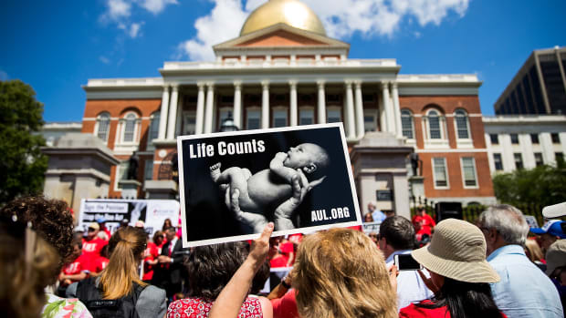Supporters of Massachusetts Citizens for Life hold signs during a rally outside the Massachusetts Statehouse on June 17th, 2019, in Boston, Massachusetts. Opposing activists were rallying in advance of consideration by lawmakers of measures aimed at loosening restrictions on abortion.