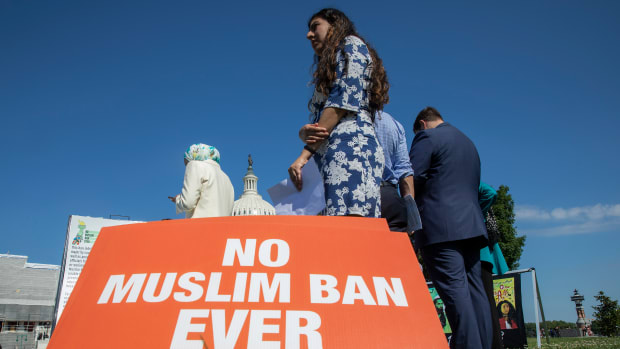 Activists protest on the anniversary of the Supreme Court's ruling upholding the Trump administration's restriction of travel to the U.S. from predominantly Muslim countries.