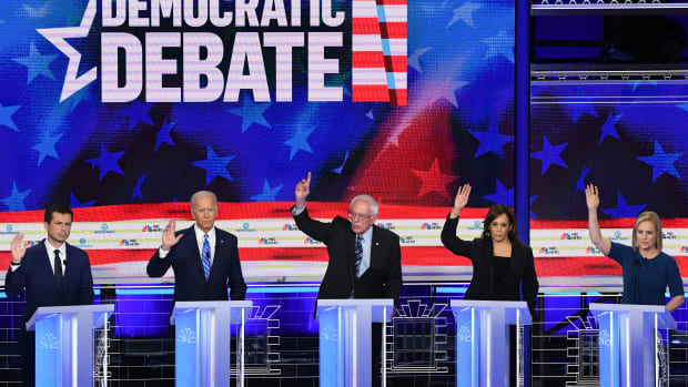 Pete Buttigieg, Joe Biden, Bernie Sanders, Kamala Harris, and Kirsten Gillibrand participate raise their hands in the second Democratic primary debate.