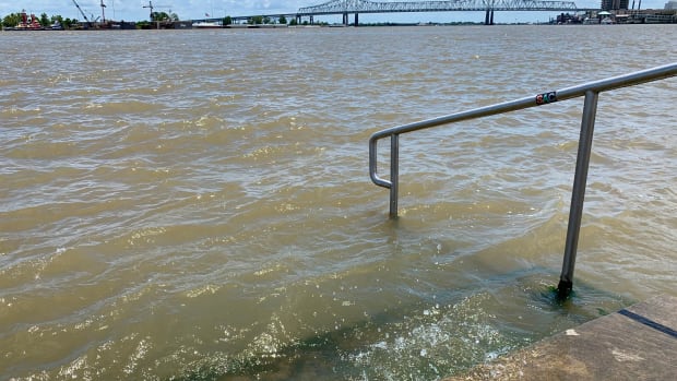The Mississippi River laps at the stairs on a protective levee in New Orleans as Tropical Storm Barry approaches on July 11th, 2019.