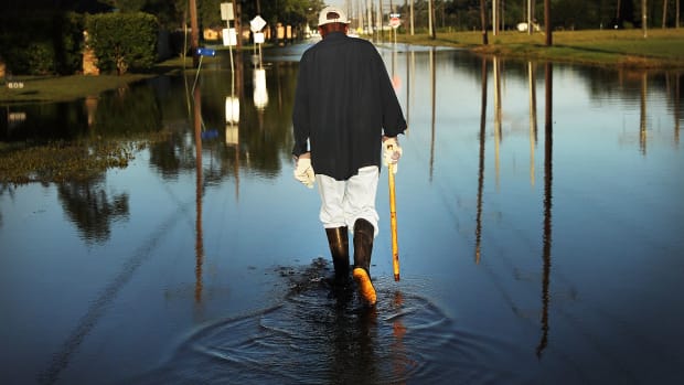 Paul Morris checks on neighbor's homes in a flooded district of Orange as Texas slowly moves toward recovery from the devastation of Hurricane Harvey on September 7th, 2017.