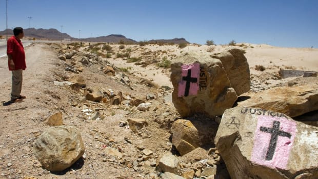 A man looks at rocks painted with crosses calling for justice, in allusion to deaths resulting from drug cartels' struggle for control in Ciudad Juarez, Mexico, on May 28th, 2008.