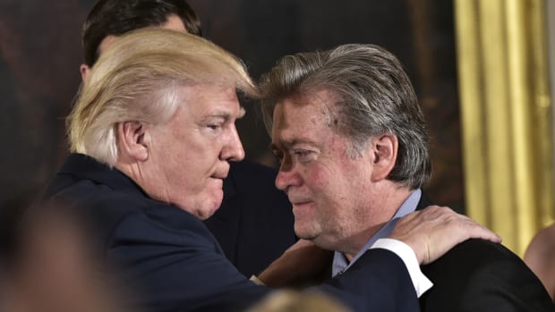 President Donald Trump congratulates then-Senior Counselor to the President Steve Bannon during the swearing-in of senior staff in the East Room of the White House on January 22nd, 2017, in Washington, D.C.
