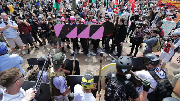 White nationalists, neo-Nazis, and members of the alt-right face anti-fascist counter-protesters at the entrance to Emancipation Park during the "Unite the Right" rally August 12th, 2017, in Charlottesville, Virginia.