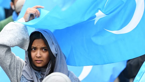 A woman takes part in a protest march of ethnic Uyghurs asking for the closure of re-education camps in China, on April 27th, 2018.