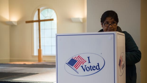 A woman casts her ballot at a church polling station in Fairfax, Virginia, during the U.S. presidential election on November 8th, 2016.