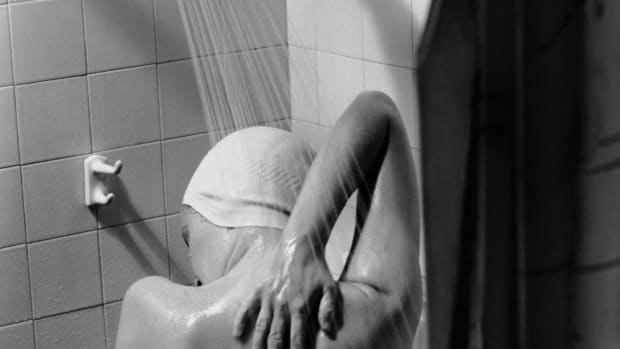 A woman takes a shower circa 1950.