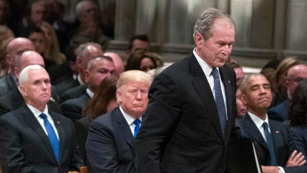 Former President George W. Bush walks past President Donald Trump to speak during the state funeral for his father, George H.W. Bush, at the National Cathedral on December 5th, 2018, in Washington, D.C.