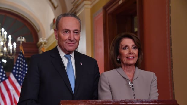 House Speaker Nancy Pelosi and Senate Democratic leader Chuck Schumer pose for pictures after delivering a response to President Donald Trump's televised address to the nation on border funding at the Capitol in Washington, D.C., on January 8th, 2019.