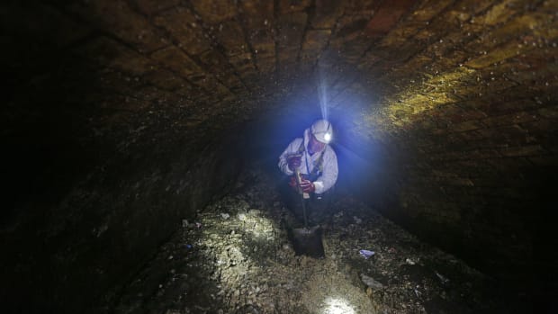 Vince Minney works in the sewers in London on December 11th, 2014, fighting against the fatbergs clogging the system.