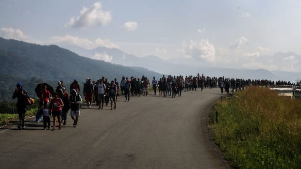Members of a caravan of Central American migrants walk along a highway on their way toward the United States on January 20th, 2019, in Huixtla, Mexico.