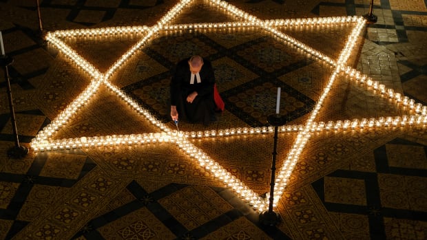 The Reverend Canon Dr. Chris Collingwood, York Minster's Canon Chancellor, lights some of the 600 candles in the form of the Star of David set out on the floor during an event to commemorate Holocaust Memorial Day in the Chapter House at York Minster on January 24th, 2019, in York, England. The ceremony in the minster is one of many international events for Holocaust Memorial Day, held on January 27th. This date marks the liberation of the Auschwitz-Birkenau concentration camp in 1945. The international theme for Holocaust Memorial Day 2019 is "Torn From Home," which encourages people to reflect on how the enforced loss of a safe place to call home is part of the trauma faced by anyone experiencing persecution and genocide. This year also marks the 25th anniversary of the Rwandan genocide, which began in April of 1994, and the 40th anniversary of the end of the Cambodian genocide, which ended in 1979.