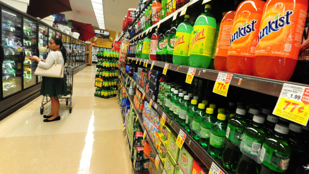 A woman shops for frozen foods on an aisle across from sodas and other sugary drinks for sale at a supermarket in Monterey Park, California.
