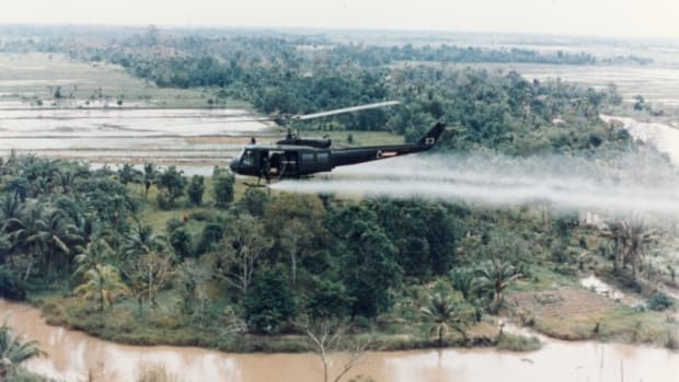 A U.S. Huey helicopter sprays Agent Orange over Vietnam.