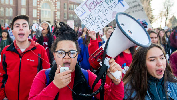 South High School seniors Johnny Hultzapple (left), Aislinn Thompson (center), and Esperanza Soledad Garcia (right) lead students on a walkout to join their striking teachers on the picket line on February 11th, 2019, in Denver, Colorado. Denver teachers are striking for the first time in 25 years after the school district and the union representing the educators failed to reach an agreement following 14 months of contract negotiations over teacher pay.