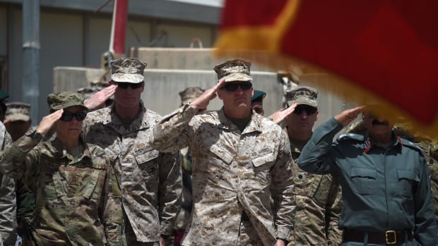 U.S. Marine Brigadier General Roger Turner and Afghan officials salute during a handover ceremony at Leatherneck Camp in Lashkar Gah in Helmand Province on April 29th, 2017.