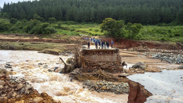 Timber company workers stand stranded on a damaged road on March 18th, 2019, at Charter Estate, in Chimanimani, eastern Zimbabwe, after Cyclone Idai ripped across Mozambique, Zimbabwe, and Malawi. The Red Cross has reported at least 215 deaths, and President Filipe Nyusi of Mozambique said he fears the death toll may reach over 1,000. Cyclone Idai tore into the center of Mozambique on the night of March 14th before barreling into neighboring Zimbabwe, bringing flash floods and ferocious winds, and washing away roads and houses.