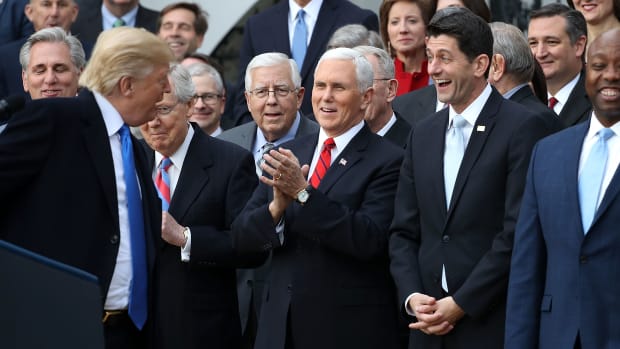 Donald Trump, Mike Pence, Mitch McConnell, and Paul Ryan celebrate the passage of the Tax Cuts and Jobs Act of 2017 on the South Lawn of the White House.