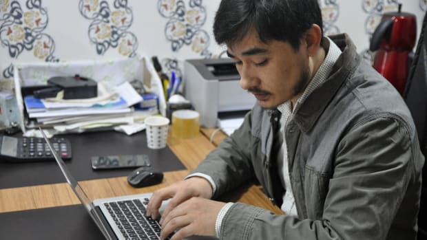 Ershat Bahtiyar, 27, digitizes an older volume by typing it directly into a word document. This one, he says, will take two days to complete.