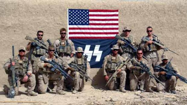 U.S. Marines pose with a SS Flag in 2012.