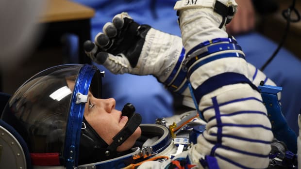 NASA astronaut Anne McClain reacts as her space suit is tested prior to the launch onboard the Soyuz MS-11 spacecraft at the Russian-leased Baikonur cosmodrome in Kazakhstan on December 3rd, 2018.