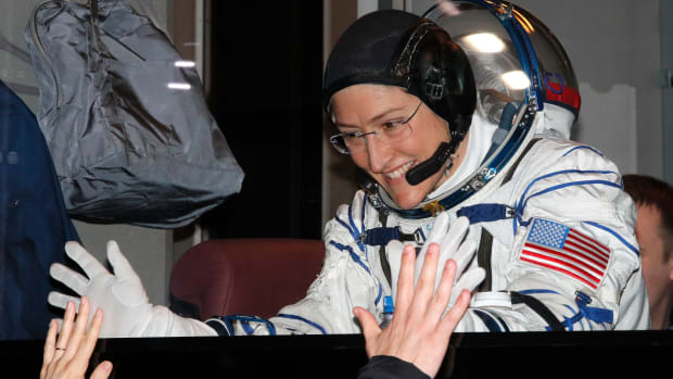 NASA astronaut Christina Koch gestures from inside a bus shortly before her expedition launched at the Russian-leased Baikonur cosmodrome in Kazakhstan on March 14th, 2019.