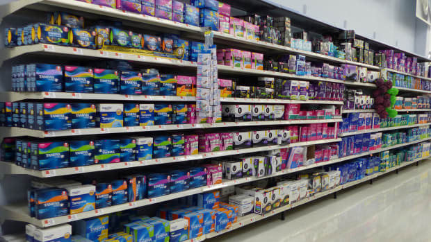Feminine hygiene products such as tampons and pads in a Walmart aisle