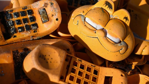 Spare parts of plastic Garfield phones littering a beach in western France.