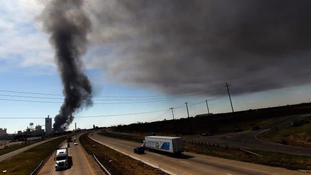 Traffic continues on Interstate 35 as Waxahachie firefighters battle a massive fire at the Magnablend chemical processing plant on October 3rd, 2011, in Waxahachie, Texas.