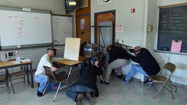 "Students" barricade a door of a classroom to block an "active shooter" during ALICE (Alert, Lockdown, Inform, Counter and Evacuate) training at the Harry S. Truman High School in Levittown, Pennsylvania, on November 3rd, 2015.