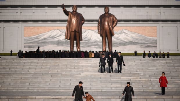 A man and child walk away after paying their respects before the statues of late North Korean leaders Kim Il-sung and Kim Jong-il, as part of celebrations marking the anniversary of the birth of Kim Il-sung, known as the Day of the Sun, on Mansu hill in Pyongyang on April 15th, 2019.