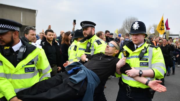 Police officers remove protesters from a blockade on Waterloo Bridge during the second day of a coordinated protest by the Extinction Rebellion group on April 16th, 2019, in London, England. More than 100 arrests have been made, with demonstrations blocking a number of locations across the capital.