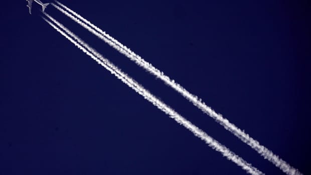 A commercial airliner flies across the sky.
