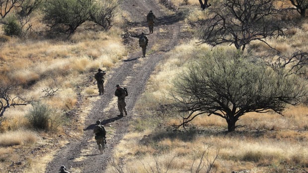Civilian paramilitaries with Arizona Border Recon search for undocumented immigrants near the U.S.–Mexico border on November 14th, 2016, near Arivaca, Arizona. The armed group, made up mostly of former U.S. military servicemen and women, does not consider itself a militia, but sees itself as supplementing Border Patrol's efforts to control illegal border activity.