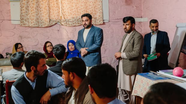 Nasib speaks with students and teachers at a youth organization in Kabul.