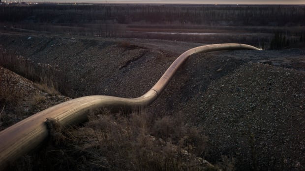 A water intake pipe for oil sands operations leads downhill to the Athabasca River on April 28th, 2015, north of Fort McMurray, Canada.