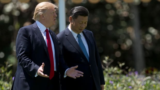President Donald Trump and Chinese President Xi Jinping walk together at the Mar-a-Lago estate in West Palm Beach, Florida, on April 7th, 2017.