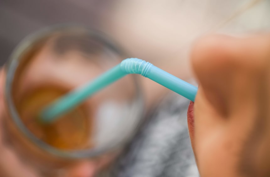 A picture taken on May 24th, 2018, in Sieversdorf, Germany, shows a woman drinking with a plastic straw.
