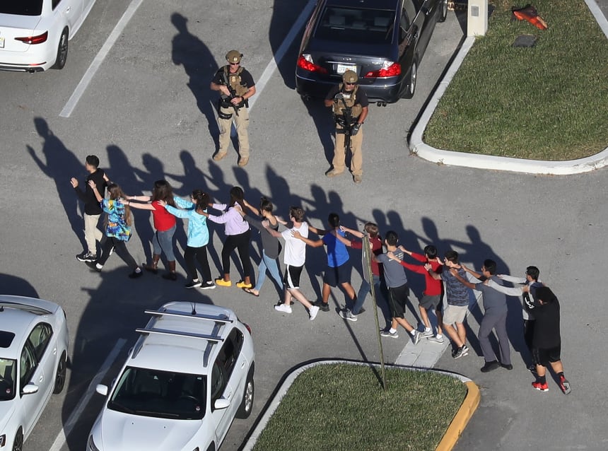 People are brought out of the Marjory Stoneman Douglas High School after a shooting on February 14th, 2018, in Parkland, Florida.