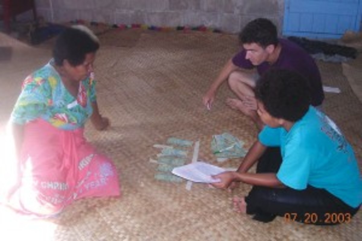 Joe Henrich and research assistant administer the Third Party Punishment Game in the village of Teci on Fiji's Yasawa Island.