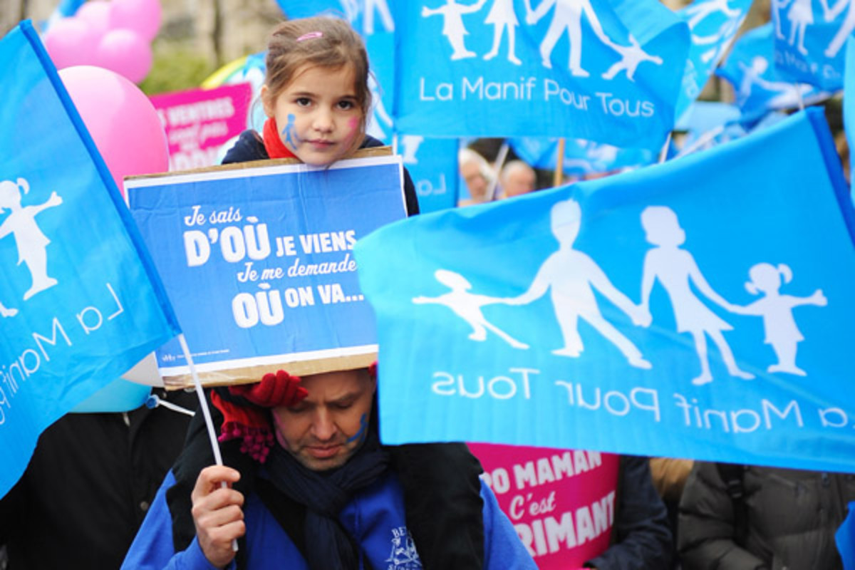 Parisians protest against the legislature's "marriage and adoption for all" draft law in January. The girl's placard reads, "I know where I come from; I wonder where we're going." (PHOTO: ANDREY MALGIN/SHUTTERSTOCK)