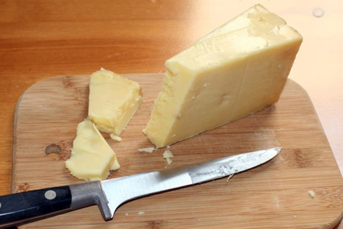 A wedge of West Country Cheddar cheese, made in Somerset. (PHOTO: J.P.Lon/WIKIMEDIA COMMONS)