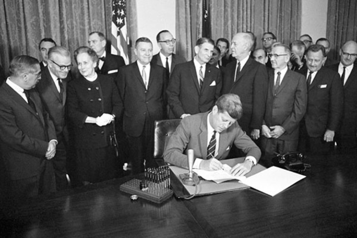 President John F. Kennedy signs the Community Mental Health Act into law on October 31, 1963. (PHOTO: BILL ALLEN/AP)