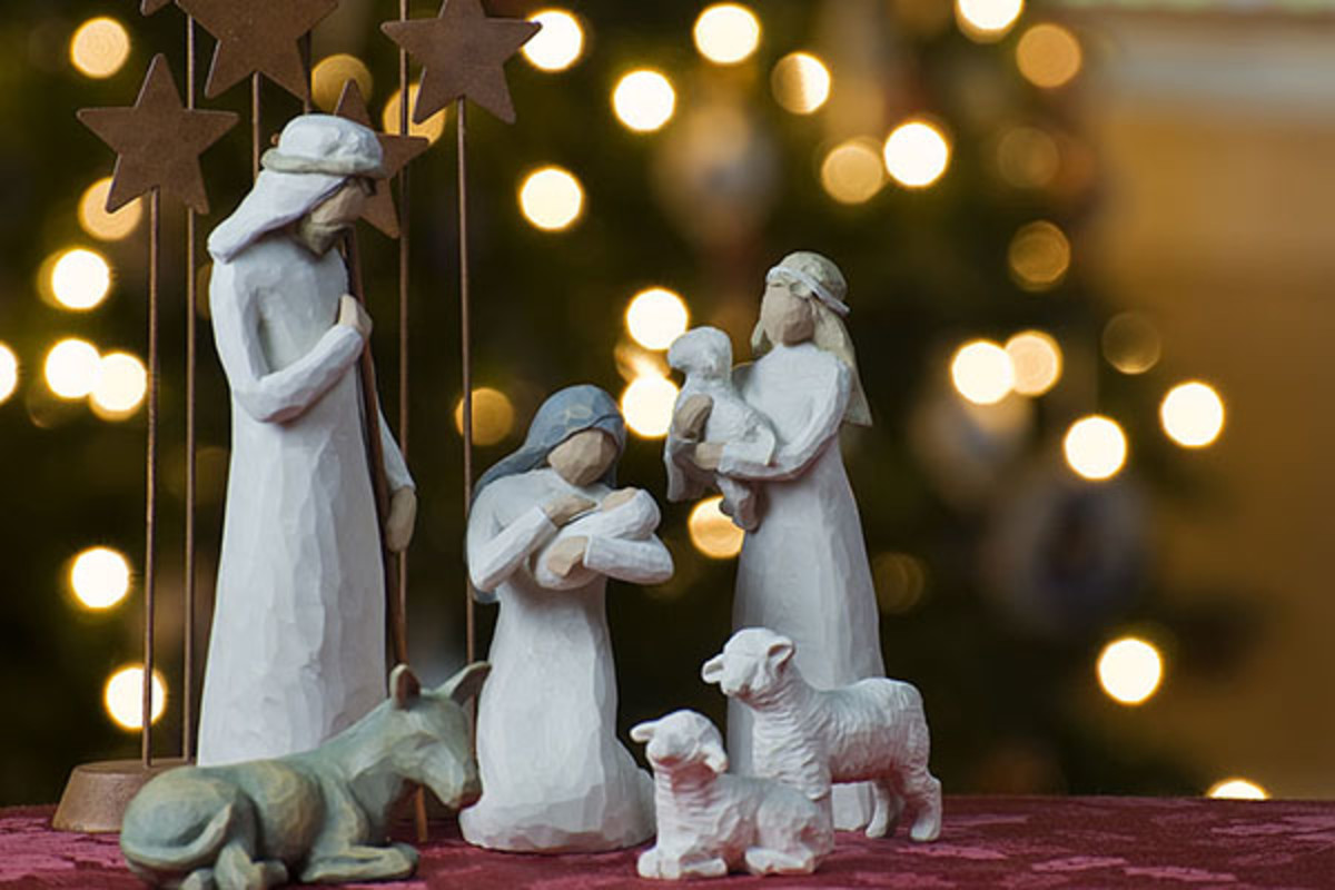 A depiction of the Nativity with a Christmas tree backdrop.