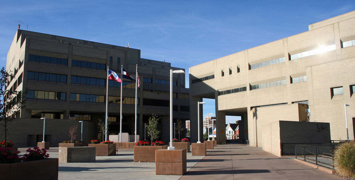 The Denver Police  administration building (left) in downtown Denver. The building on the  right is the former pre-trial detention facility. (Photo: Jeffrey Beall/Wikimedia Commons)