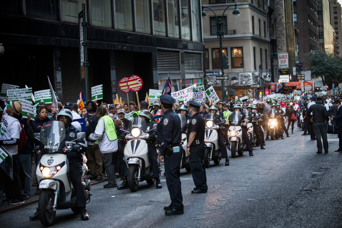 Police officers monitor Occupy Wall Street  protesters as they march from the United Nations building to Bryant  Park on September 17, 2013, in New York City.  (Photo: Andrew Burton/Getty Images)